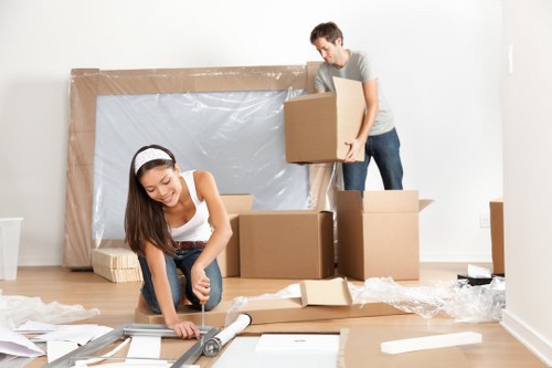 A professional removals team carrying boxes safely