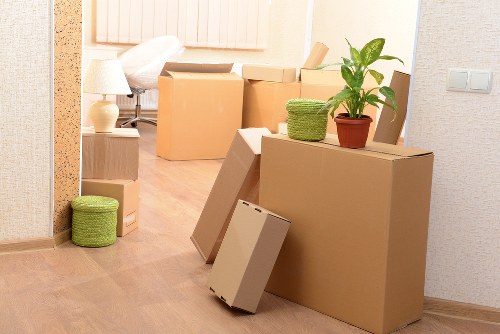 Movers handling fragile belongings with protective packing materials